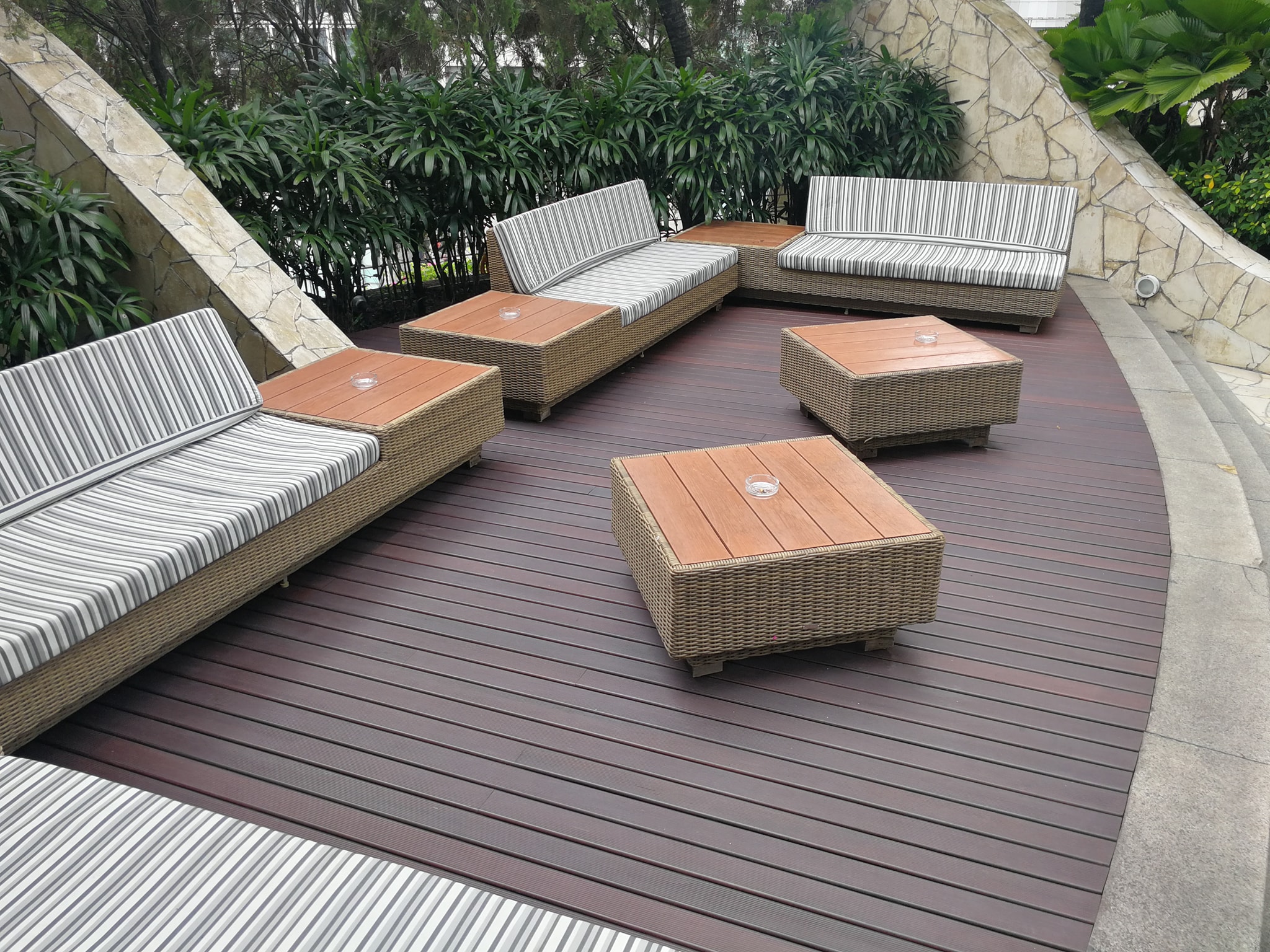 Finished timber deck and wooden tabletops in an outdoor seating area